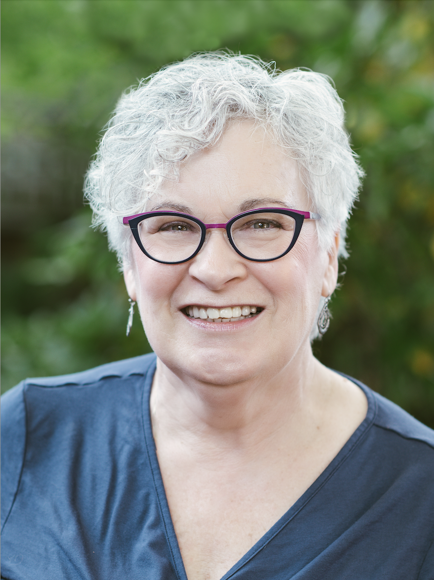 Johanna Simmons in a blue shirt with a green blurred out background